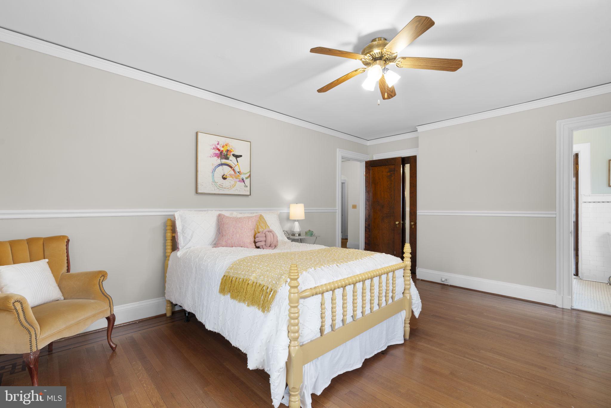 414 Old Orchard Road Baltimore, MD 21229 - Photo 36 of 84 a bedroom with a bed and a chandelier