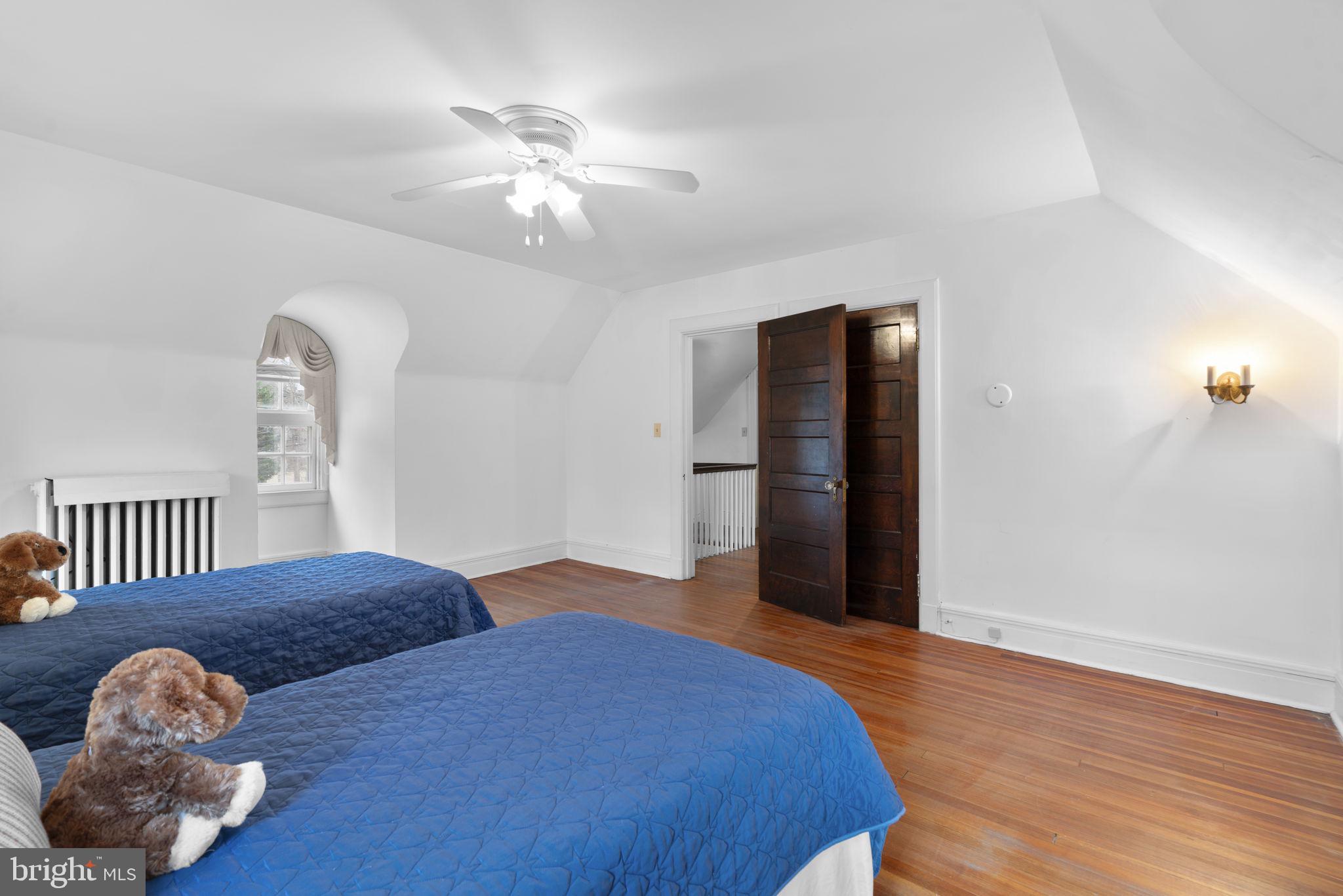 414 Old Orchard Road Baltimore, MD 21229 - Photo 49 of 84 a bedroom with a bed and a chandelier