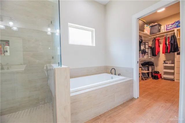 a spacious bathroom with a bathtub and shower