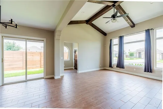 a view of an empty room with glass door