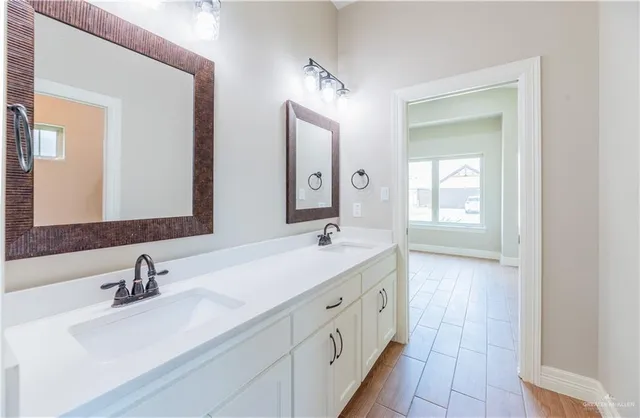 a bathroom with 2 sink tub and a mirror