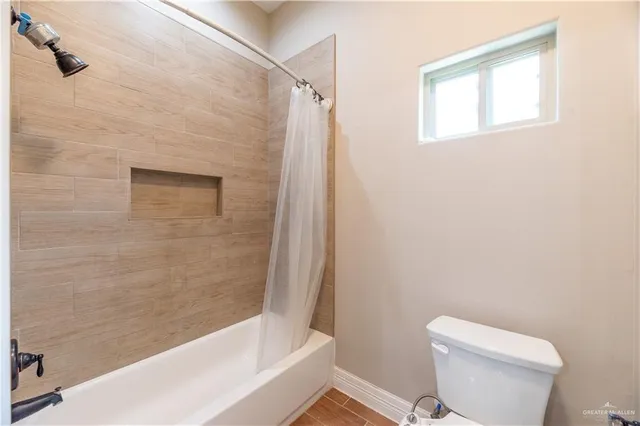 a bathroom with a shower and a toilet