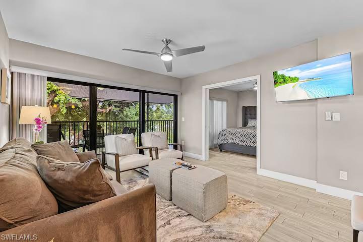 600 Neapolitan Way, Unit 341 Naples, FL 34103 - Photo 1 of 28 a living room with furniture and a large window
