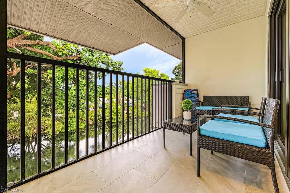600 Neapolitan Way, Unit 341 Naples, FL 34103 - Photo 16 of 28 a roof deck with a table and chairs