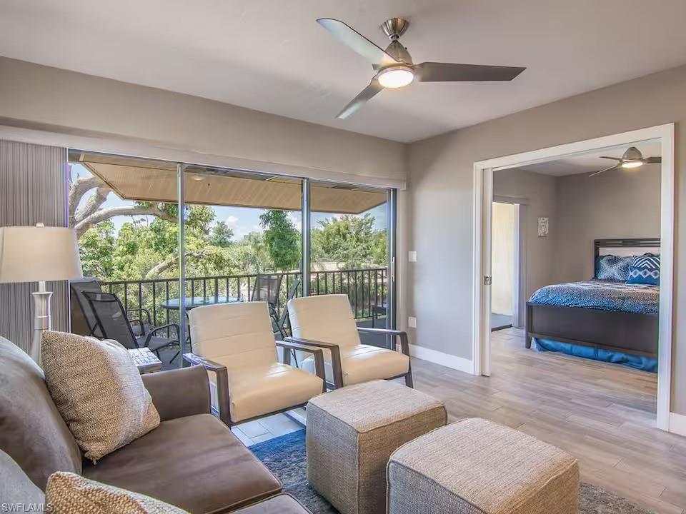 600 Neapolitan Way, Unit 341 Naples, FL 34103 - Photo 3 of 28 a living room with furniture and a large window