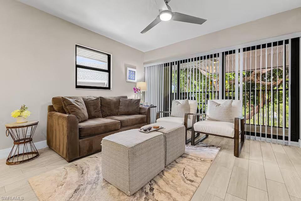 600 Neapolitan Way, Unit 341 Naples, FL 34103 - Photo 5 of 28 a living room with furniture and a large window