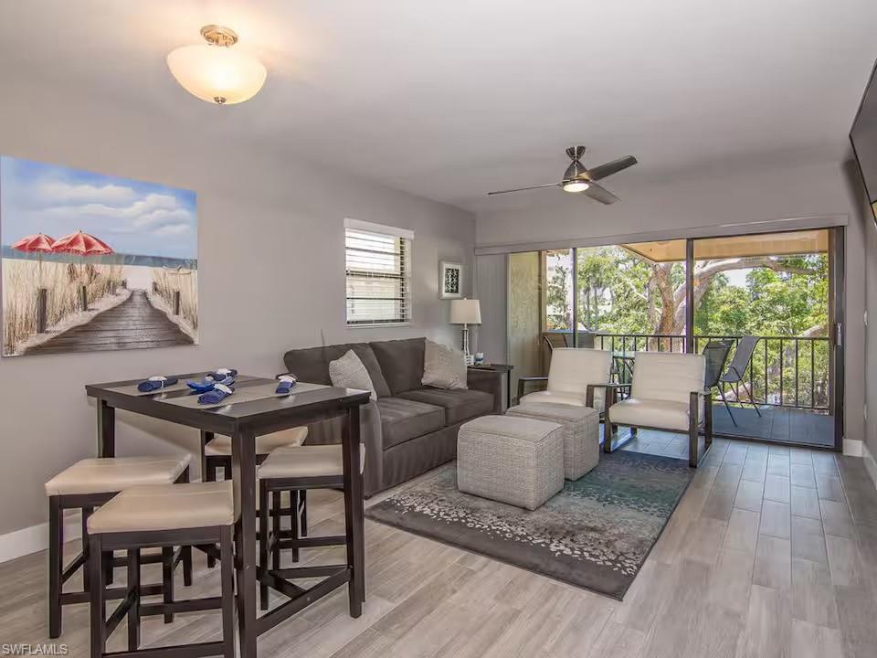 600 Neapolitan Way, Unit 341 Naples, FL 34103 - Photo 6 of 28 a living room with furniture and a window