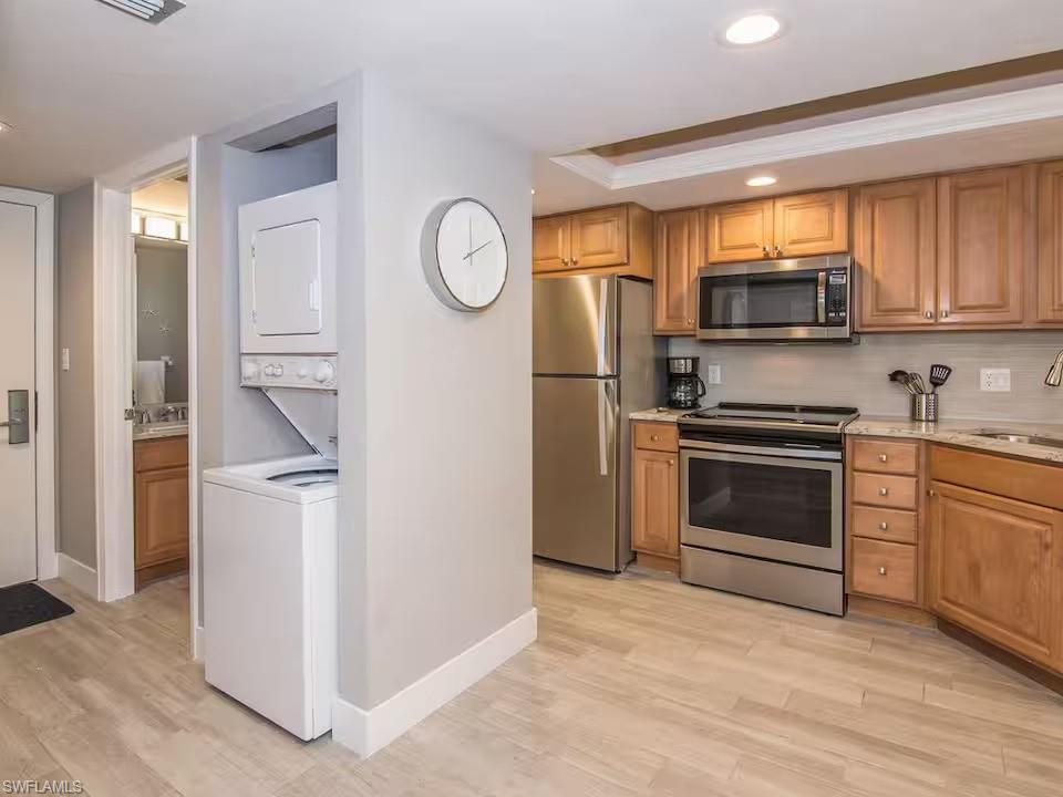 600 Neapolitan Way, Unit 341 Naples, FL 34103 - Photo 9 of 28 a kitchen with a refrigerator stove and a sink