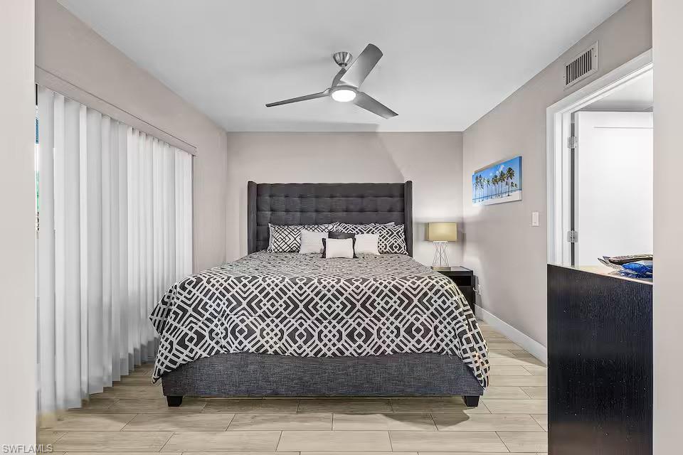 600 Neapolitan Way, Unit 341 Naples, FL 34103 - Photo 10 of 28 a bedroom with a bed and window