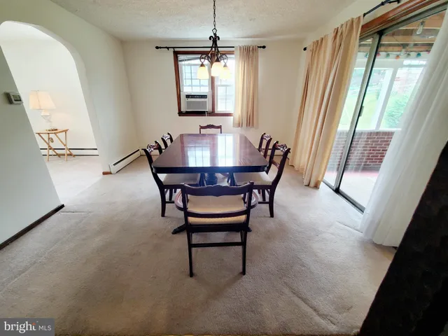 a view of a dining room with furniture and a window