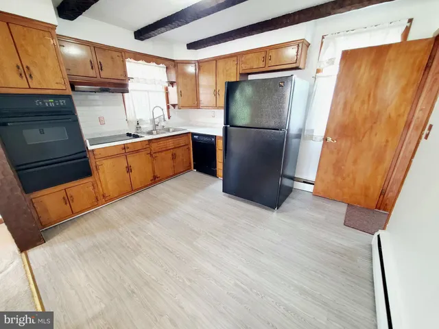 a kitchen with stainless steel appliances a refrigerator and a refrigerator