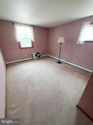 a view of a room with furniture and a window