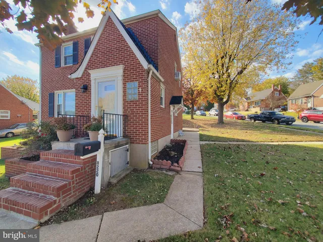 a view of a house with a yard and sitting area
