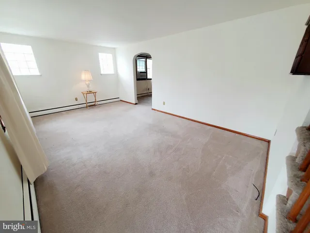 an empty room with windows and entrance