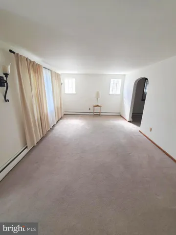 a view of empty room with windows and closet