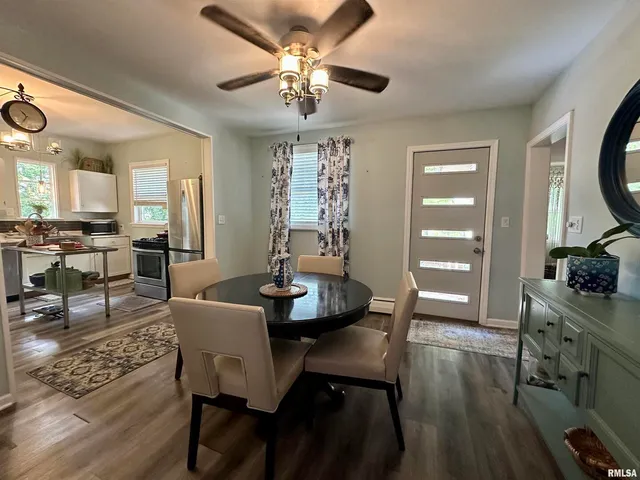 a view of a dining room with furniture window and wooden floor