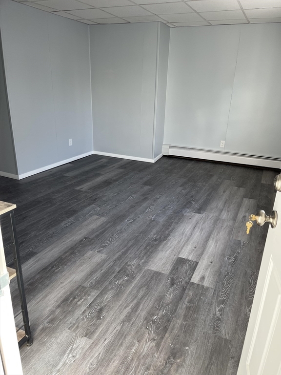 a view of room with wooden floor