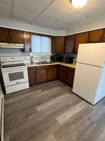 a kitchen with a cabinets and white appliances