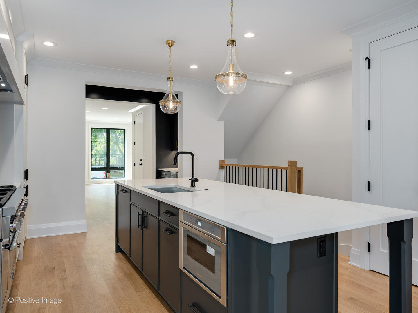 646 West Webster Avenue, Unit 1 Chicago, IL 60614 - Photo 7 of 11 an open kitchen with a sink and dishwasher with wooden floor