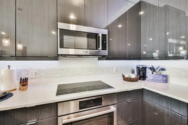 a kitchen with kitchen island a sink appliances and cabinets