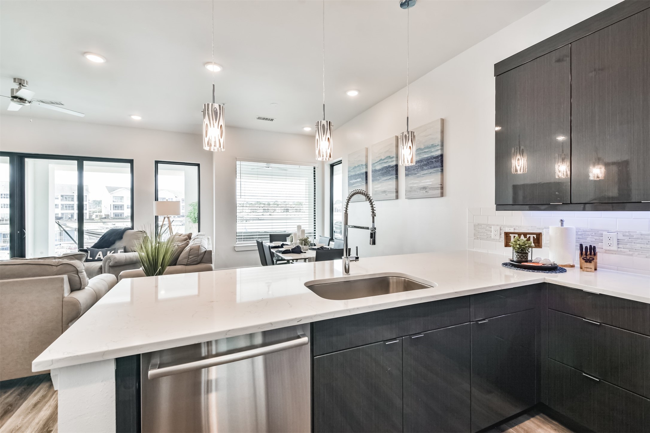 199 Waterpoint Court, Unit 106 Conroe, TX 77304 - Photo 50 of 50 a kitchen with counter top space a sink cabinets and appliances