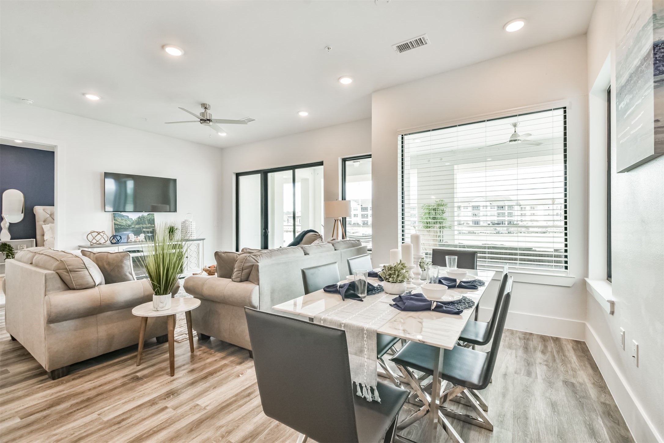 199 Waterpoint Court, Unit 106 Conroe, TX 77304 - Photo 17 of 50 a living room with furniture and a large window