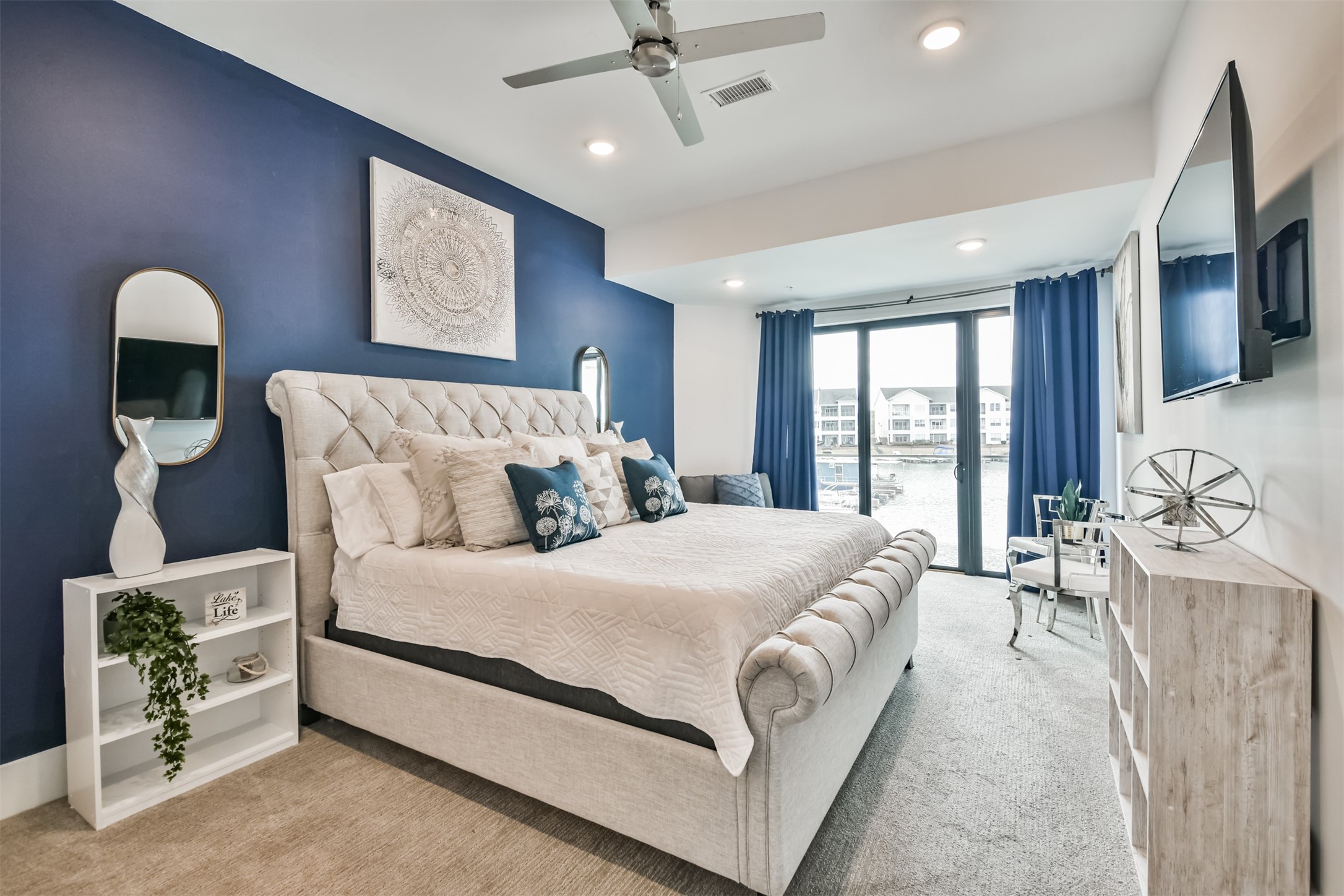 199 Waterpoint Court, Unit 106 Conroe, TX 77304 - Photo 20 of 50 a bed room with a bed and a chair