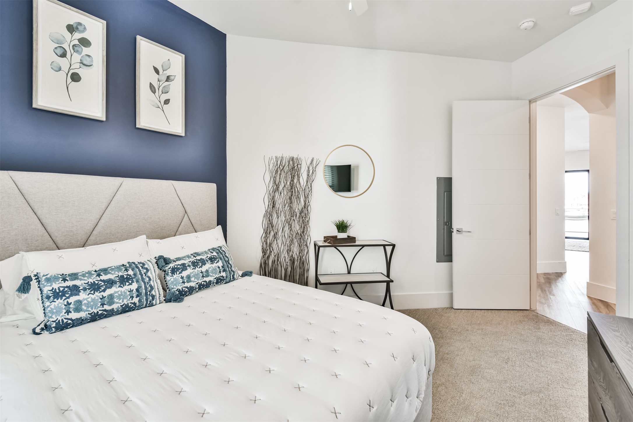 199 Waterpoint Court, Unit 106 Conroe, TX 77304 - Photo 29 of 50 a bedroom with a bed a painting on the wall and a large window