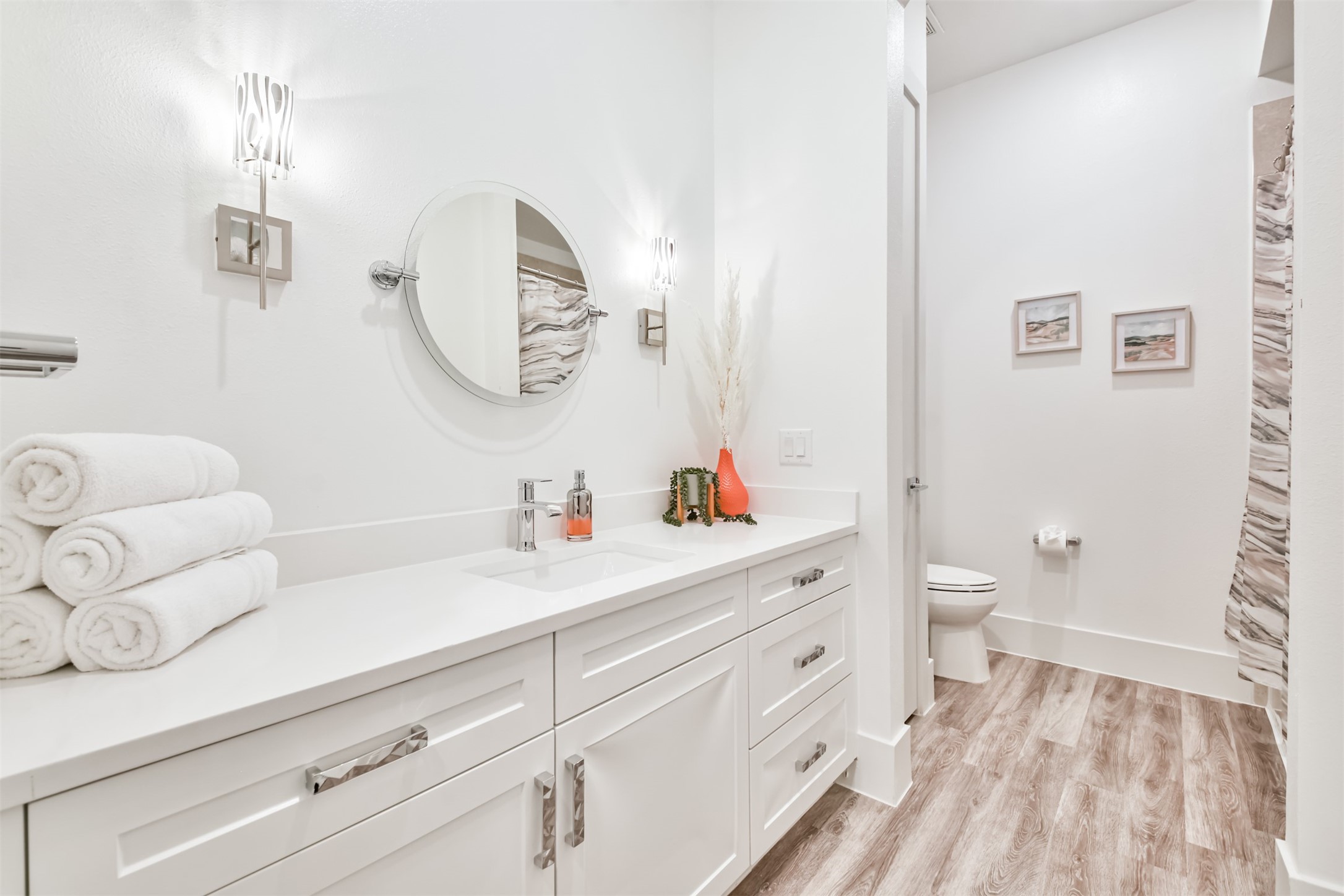 199 Waterpoint Court, Unit 106 Conroe, TX 77304 - Photo 30 of 50 a bathroom with a sink a toilet and a mirror