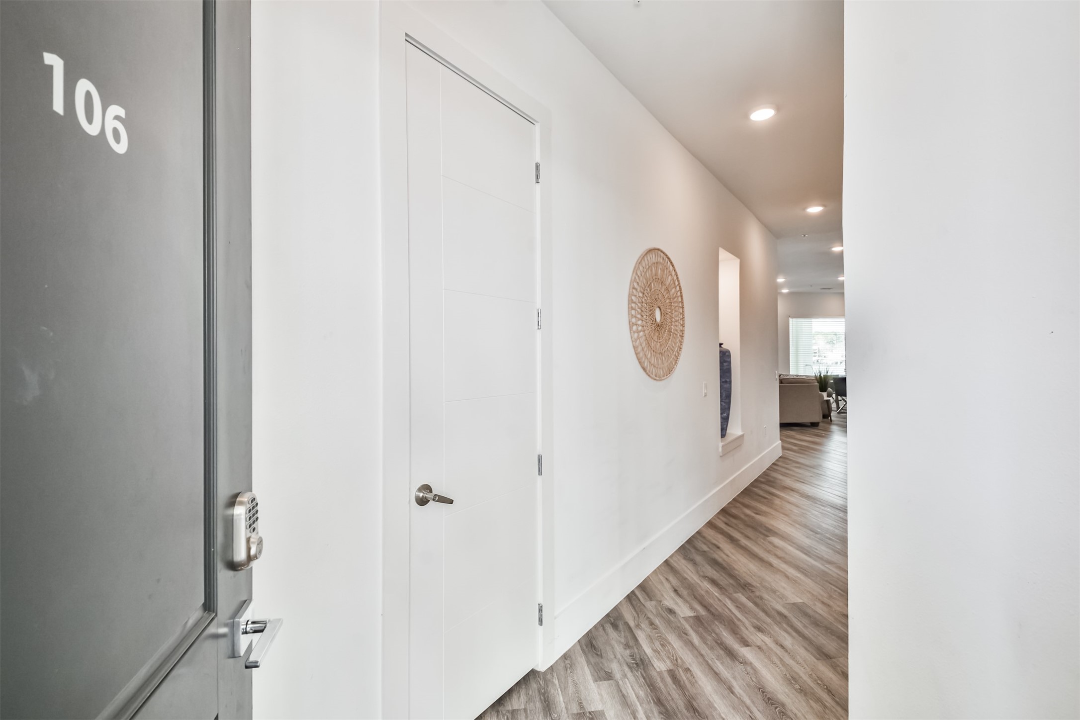 199 Waterpoint Court, Unit 106 Conroe, TX 77304 - Photo 34 of 50 a view of a hallway with wooden floor