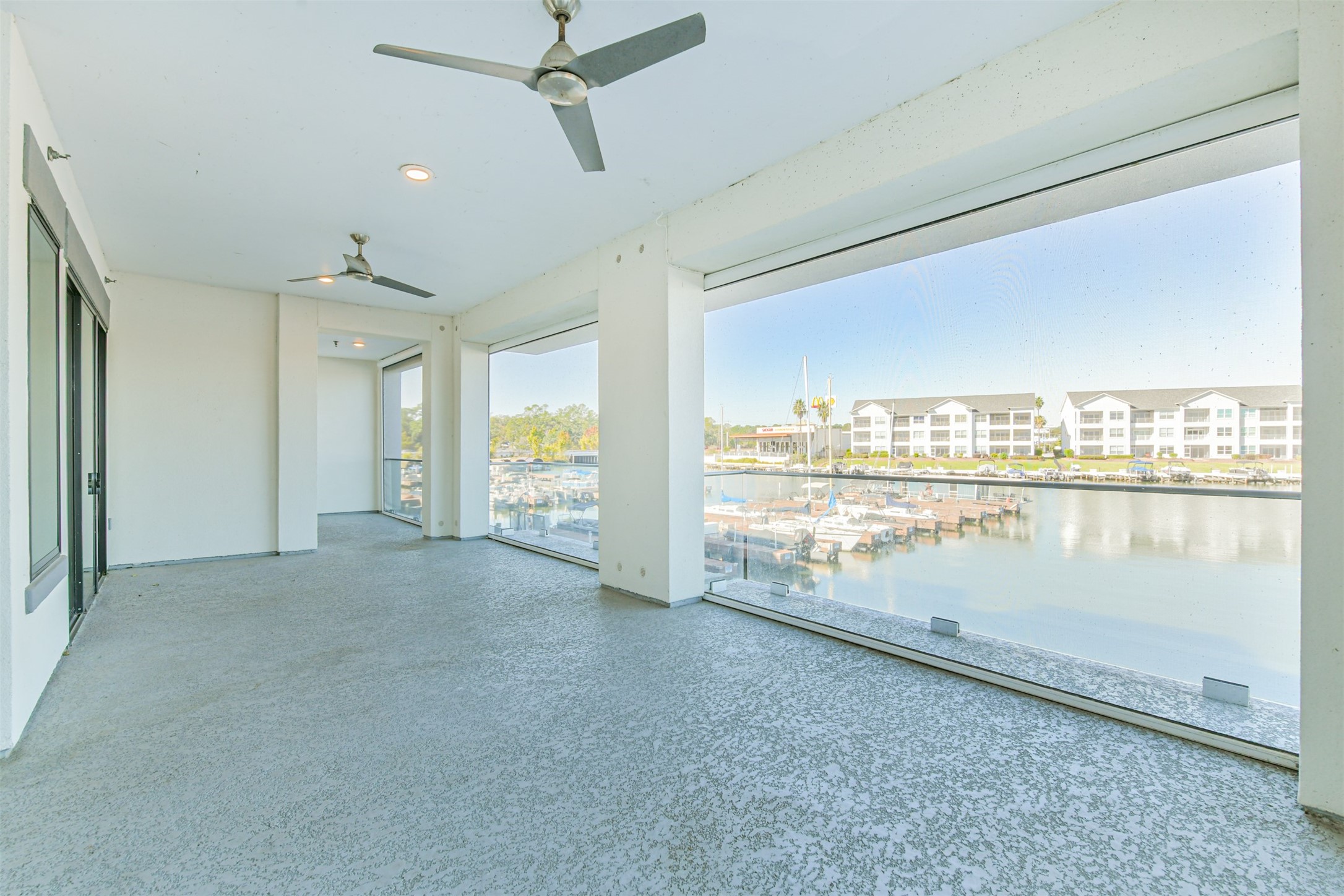 199 Waterpoint Court, Unit 106 Conroe, TX 77304 - Photo 37 of 50 This is your private balcony extending from Primary Bedroom all the way over to the corner where the Dining Room is--note the glass railing so you have unobstructed views.