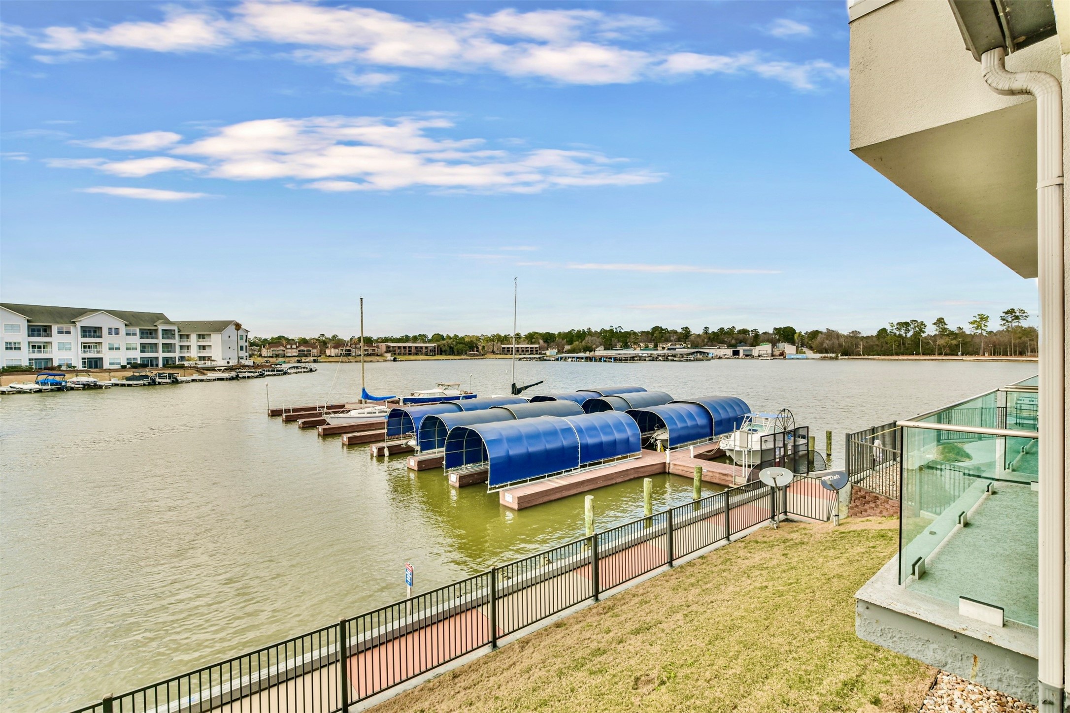 199 Waterpoint Court, Unit 106 Conroe, TX 77304 - Photo 4 of 50 a view of a lake with houses