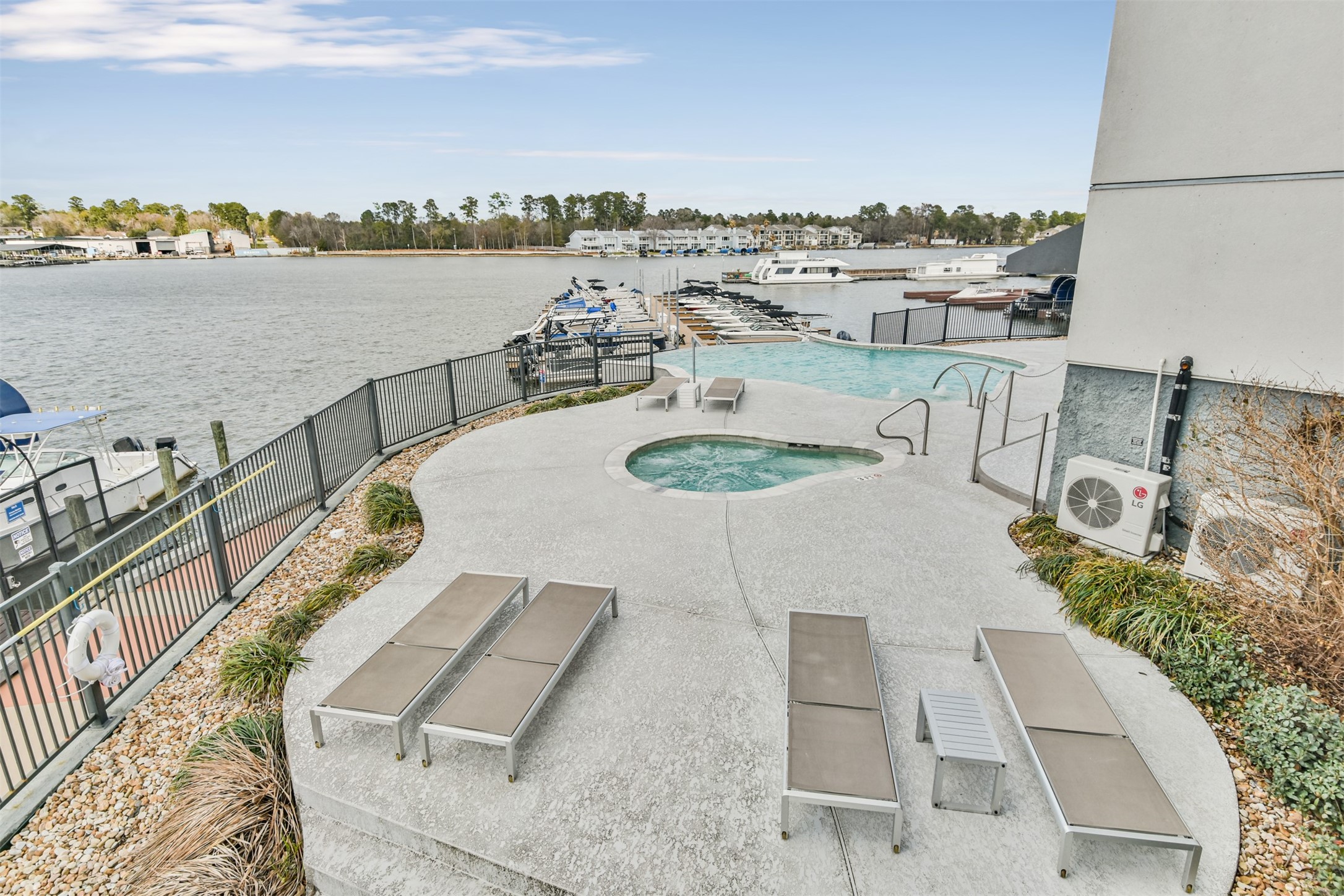199 Waterpoint Court, Unit 106 Conroe, TX 77304 - Photo 39 of 50 a terrace with a table and chairs next to a yard