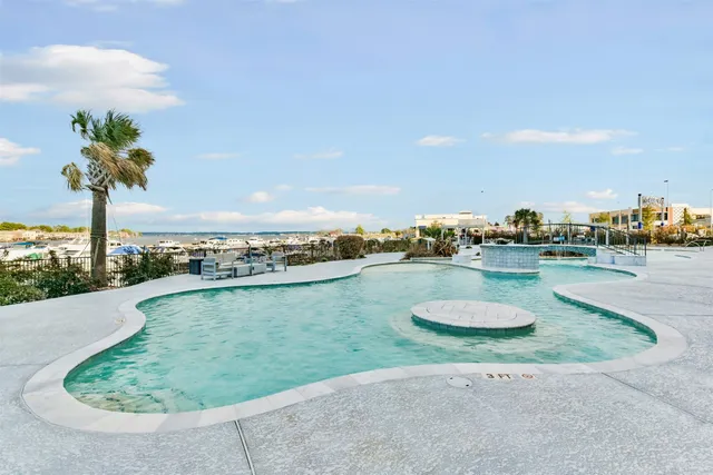 a swimming pool with outdoor seating and yard