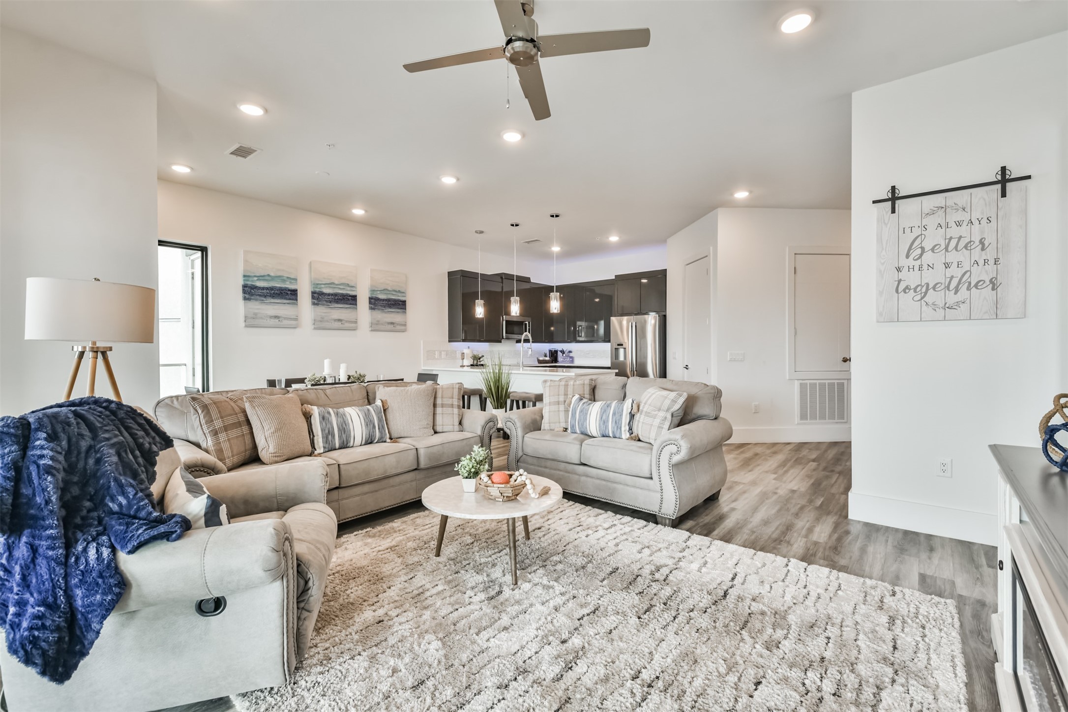 199 Waterpoint Court, Unit 106 Conroe, TX 77304 - Photo 49 of 50 a living room with furniture or kitchen view and a wooden floor