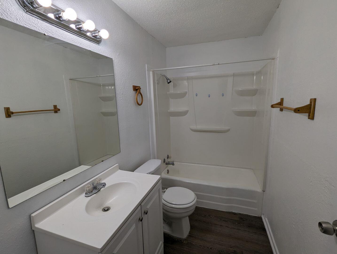 535 42nd Street, Unit A & B Lubbock, TX 79404 - Photo 11 of 13 a bathroom with a sink a toilet and shower