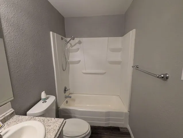 a bathroom with a toilet and a bath tub