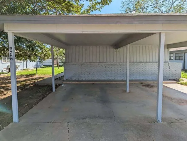 a view of an empty room with a floor to ceiling window