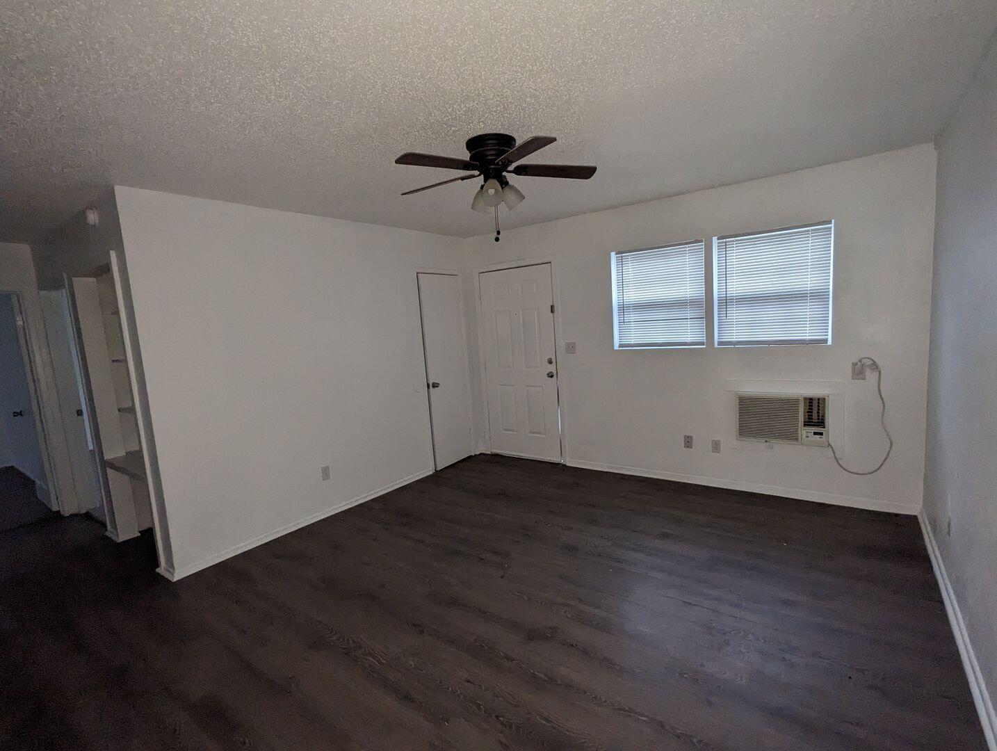 535 42nd Street, Unit A & B Lubbock, TX 79404 - Photo 4 of 13 a view of a livingroom with wooden floor and a ceiling fan