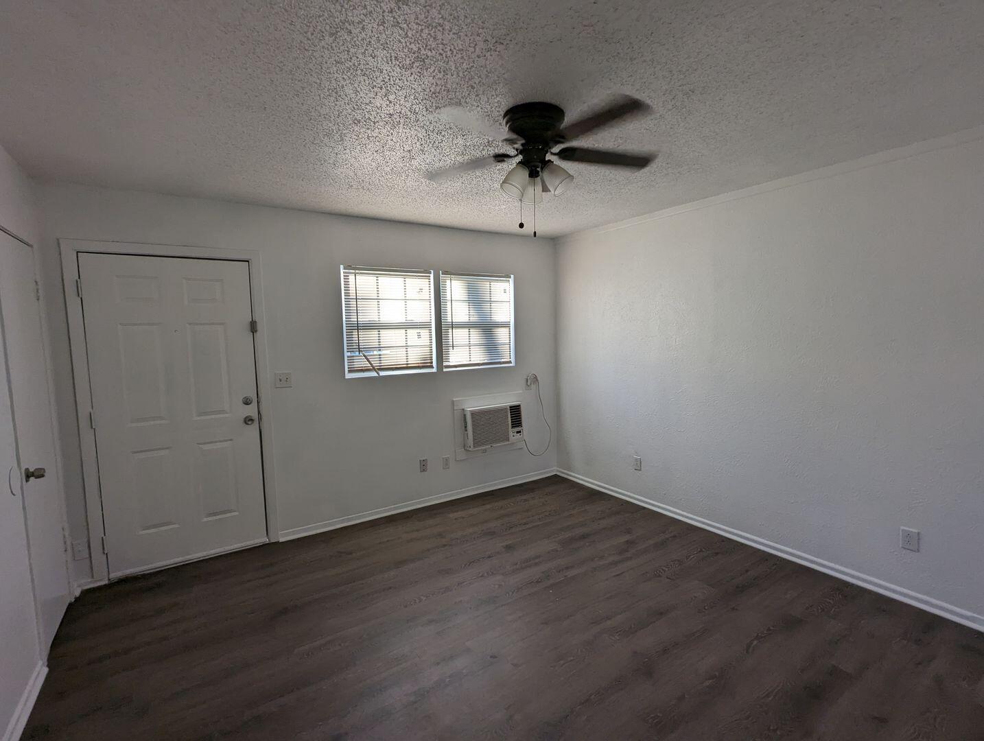 535 42nd Street, Unit A & B Lubbock, TX 79404 - Photo 5 of 13 a view of an empty room with a window and wooden floor