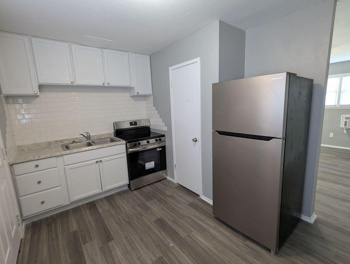535 42nd Street, Unit A & B Lubbock, TX 79404 - Photo 7 of 13 a kitchen with a refrigerator and a stove top oven