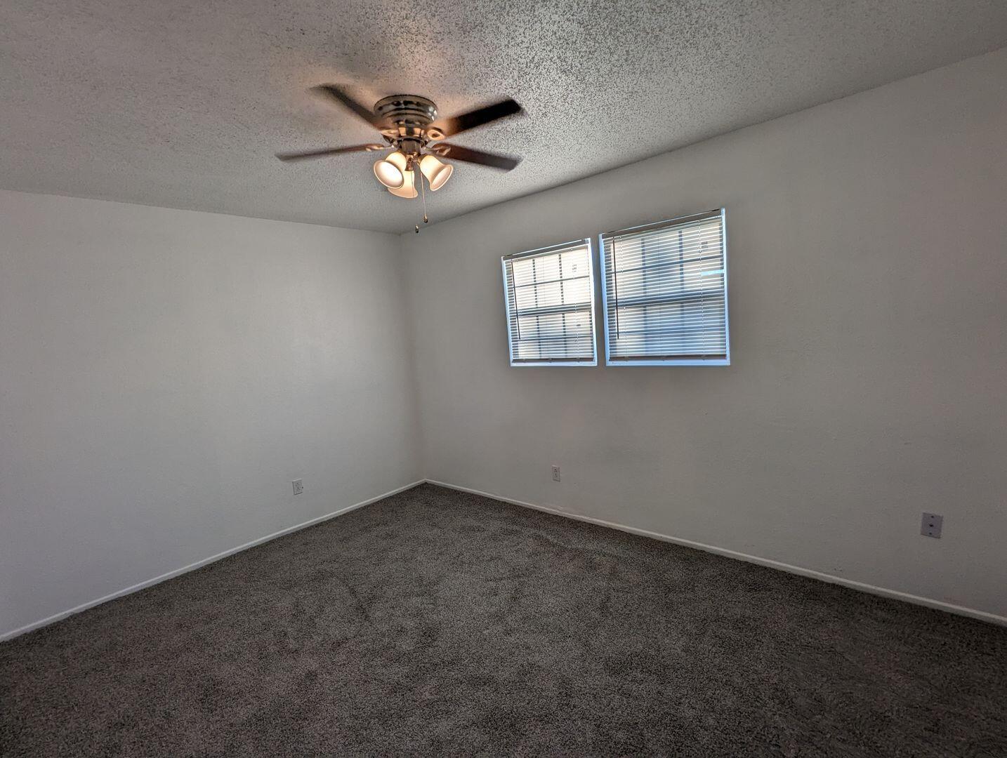 535 42nd Street, Unit A & B Lubbock, TX 79404 - Photo 10 of 13 a view of an empty room with a chandelier fan