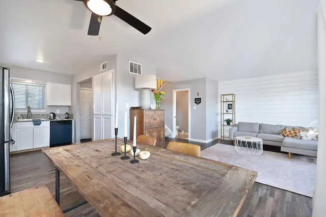 a living room with stainless steel appliances kitchen island granite countertop furniture and a kitchen view