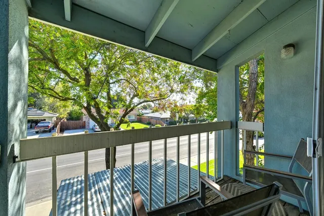 a balcony with furniture and a potted plant