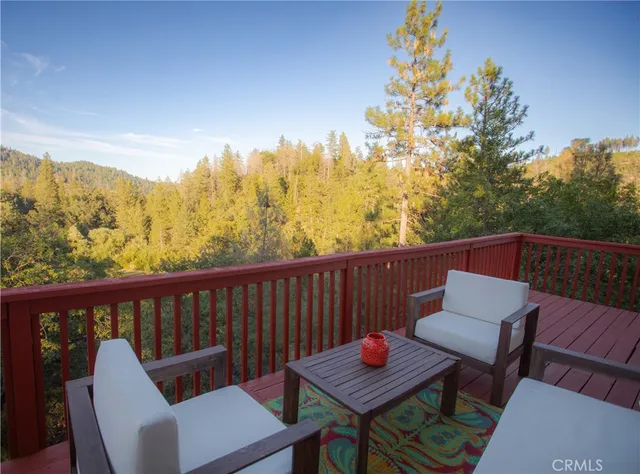 a view of a chair and table on the deck