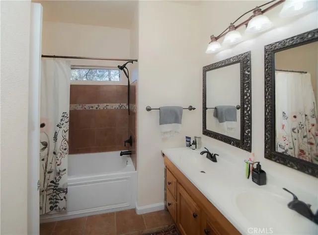 a bathroom with a tub sink and mirror