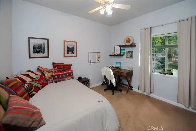 a bedroom with a bed and a window