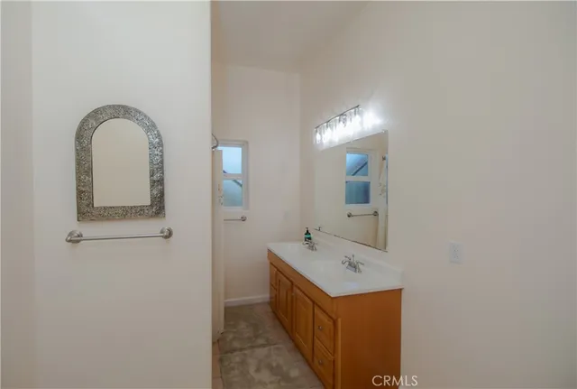 a bathroom with a double vanity sink and mirror