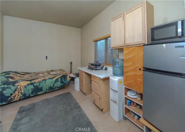 a bedroom with bed and cabinets