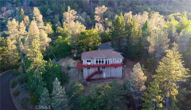 a view of a house with a yard and a tree